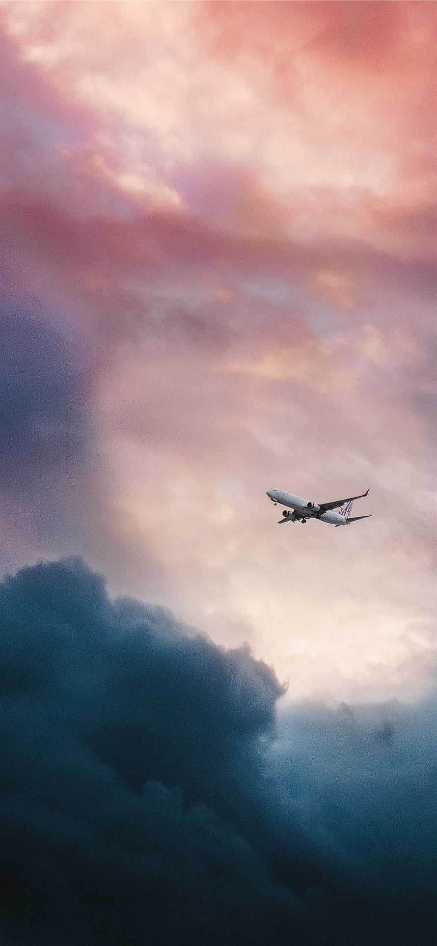 Commercial Jetliner Cruising Above Dramatic Clouds at Sunset HD phone wallpaper