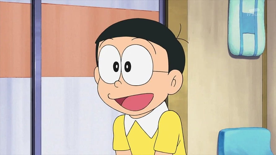 Nobita Nobi from Doraemon in a cheerful yellow shirt with a bright smile HD wallpaper