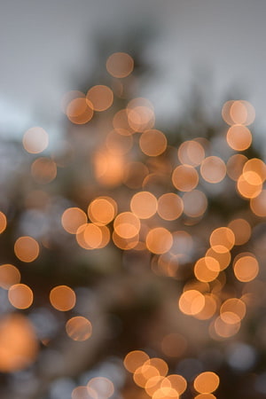 Warm Golden Bokeh Lights Against Soft Gray Background HD phone wallpaper