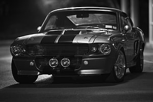 Classic 1969 Ford Mustang Fastback with Racing Stripes in Black and White Night Photography HD wallpaper