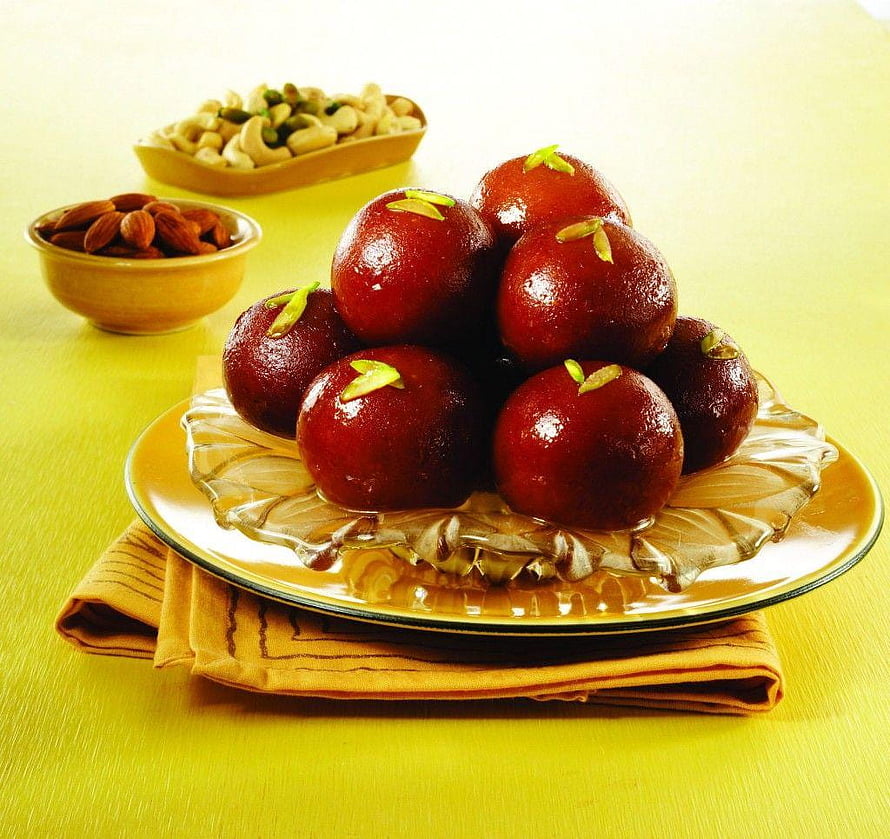 Glossy Gulab Jamun Sweets with Pistachio Garnish on a Glass Plate HD wallpaper