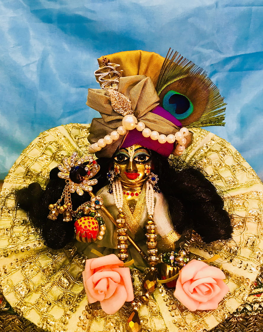 Ornate Krishna Doll with Peacock Feather Headdress and Gold Jewelry HD phone wallpaper