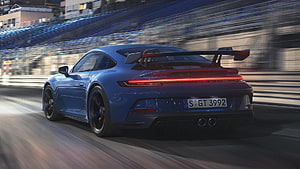 Blue Porsche 911 GT3 Rear View on Race Track with Motion Blur and Large Rear Wing HD wallpaper