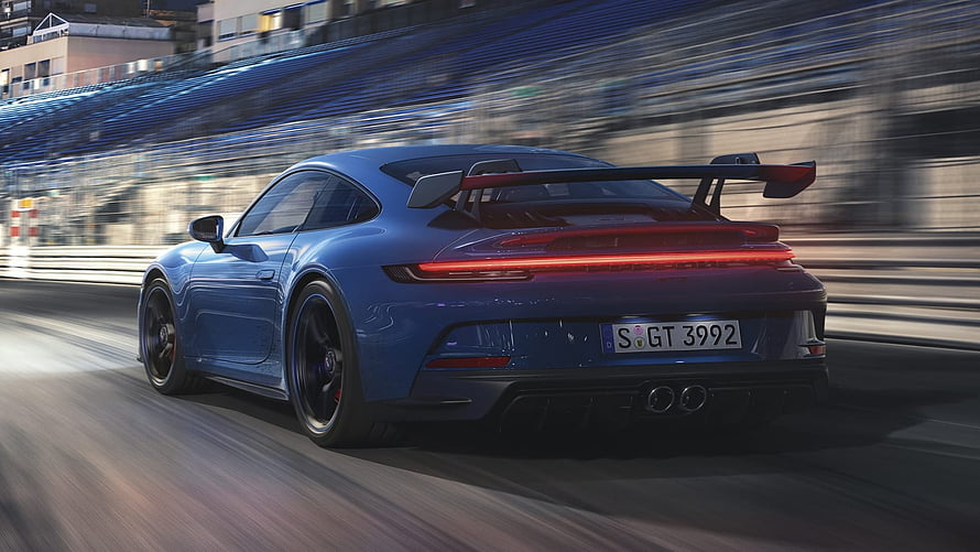 Blue Porsche 911 GT3 Rear View on Race Track with Motion Blur and Large Rear Wing HD wallpaper