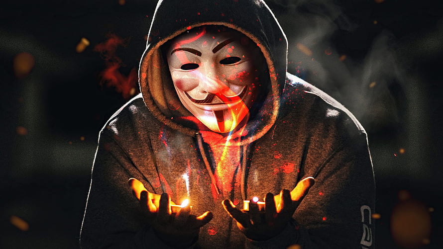 Anonymous Guy Fawkes Mask Figure Holding Candles in Dark Atmosphere HD wallpaper