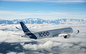 Airbus A350-1000 Commercial Jetliner Cruising Above Snow-Capped Mountain Range HD wallpaper