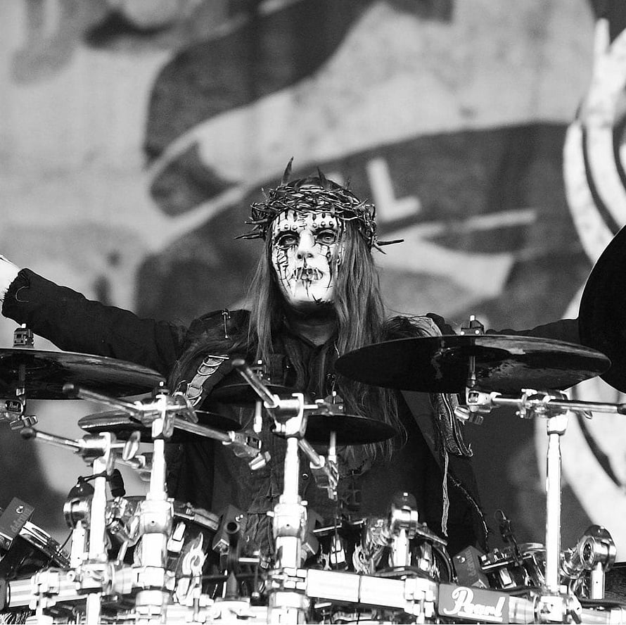 Joey Jordison of Slipknot performing on drums in full mask and crown at a live concert HD wallpaper