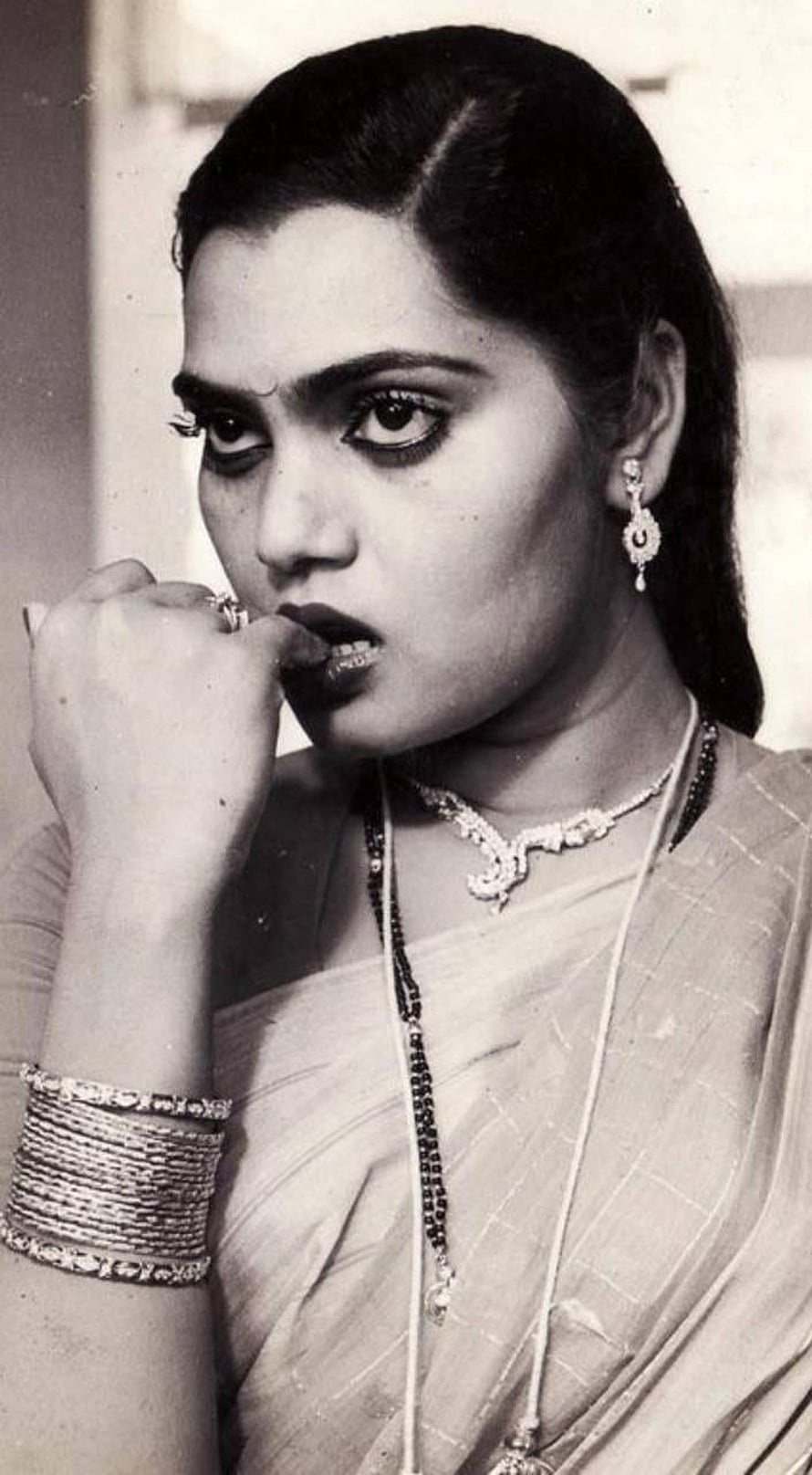 Silk Smitha in a vintage black and white portrait wearing traditional Indian jewelry and a sari HD phone wallpaper