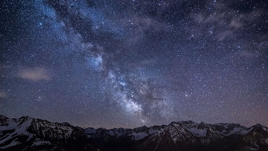 Milky Way Galaxy Arching Over Snow-Capped Mountain Ranges Under a Starry Night Sky HD wallpaper