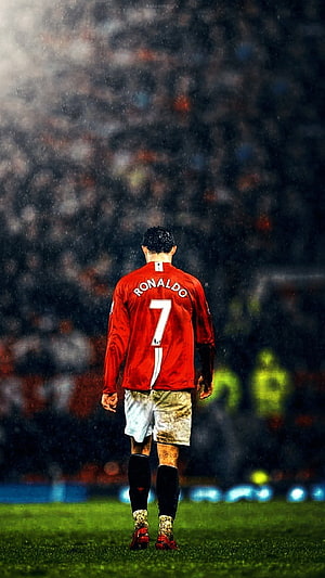 Cristiano Ronaldo Walking on the Pitch in Manchester United Kit Under Rain HD phone wallpaper