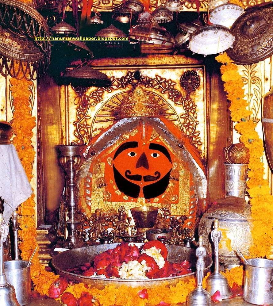 Salasar Balaji Temple Shrine with Marigold Garlands and Brass Ritual Vessels HD phone wallpaper