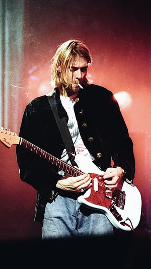 Kurt Cobain performing on stage with a Fender electric guitar and cigarette HD phone wallpaper