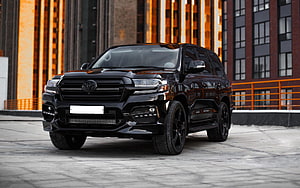 Black Toyota Land Cruiser 200 Series SUV Parked in Front of Modern Industrial Architecture HD wallpaper