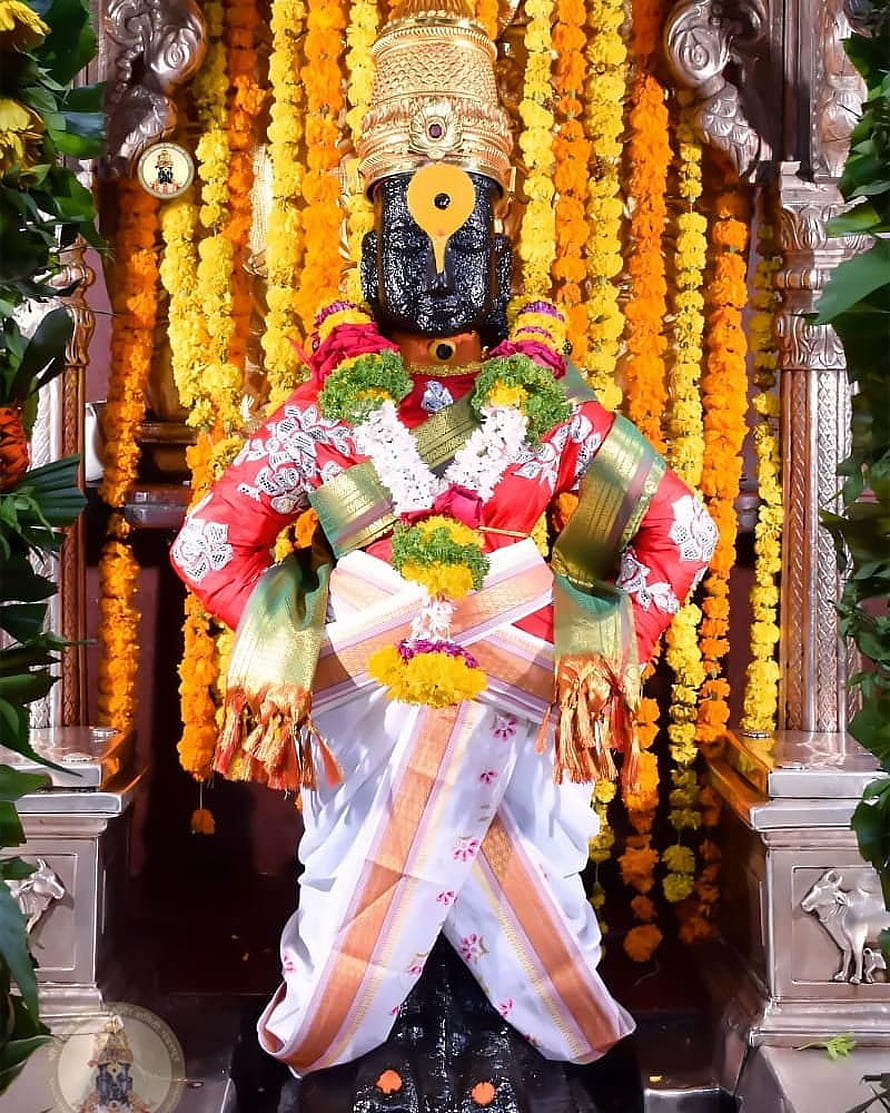 Ornate Vitthal Rakhumai Deity Adorned in Traditional Red Attire and Marigold Garlands HD phone wallpaper