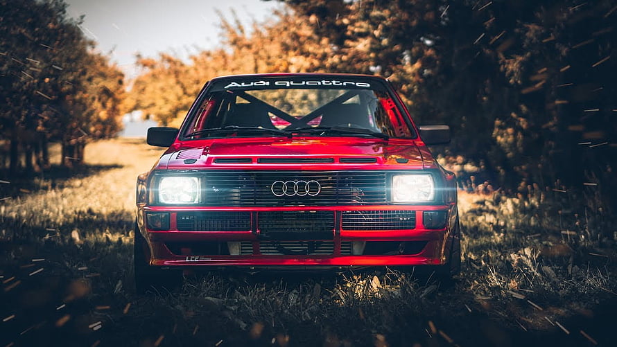 Red Audi Quattro S1 Rally Car Front View on Gravel Road with Autumn Trees HD wallpaper