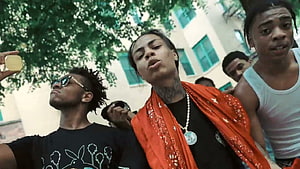 Kay Flock and friends in a vibrant outdoor street scene with an orange bandana HD wallpaper