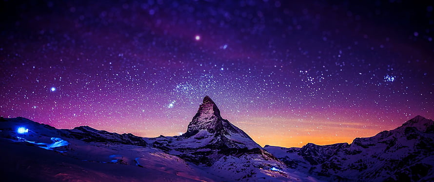 Matterhorn Peak Under a Starry Night Sky with Purple and Orange Aurora Glow HD wallpaper