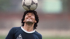 Diego Maradona Balancing a Classic Soccer Ball on His Head During Training HD wallpaper