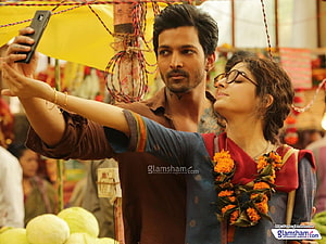 Sanam Teri Kasam movie still of couple taking a selfie at a vibrant market HD wallpaper