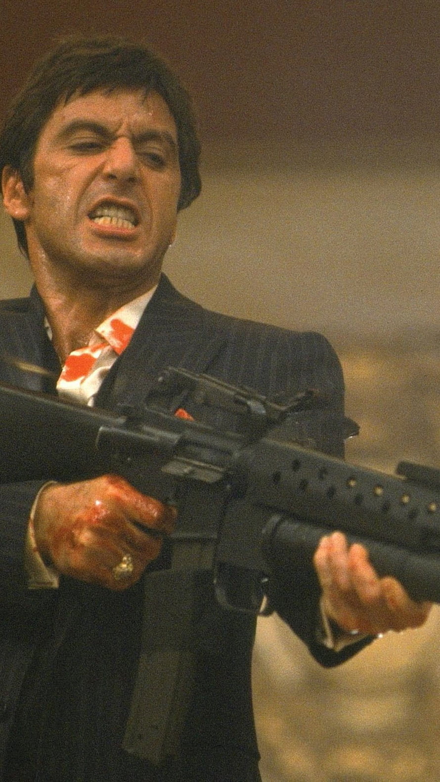 Al Pacino as Tony Montana in Scarface holding an assault rifle in a dark suit HD phone wallpaper