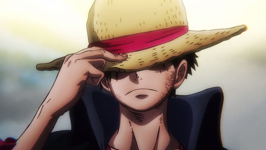Monkey D. Luffy from One Piece in a somber close-up wearing his iconic straw hat HD wallpaper