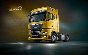 MAN TGX Individual Yellow Heavy-Duty Truck Cab in Dramatic Studio Lighting HD wallpaper