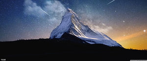 Matterhorn Peak Under a Starry Night Sky with the Milky Way and Shooting Stars HD wallpaper
