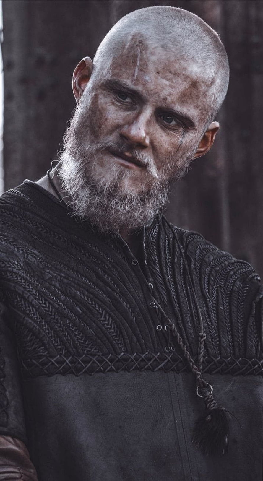 Bjorn Lothbrok Portrait in Viking Armor with Weathered Beard and Dark Tunic HD phone wallpaper