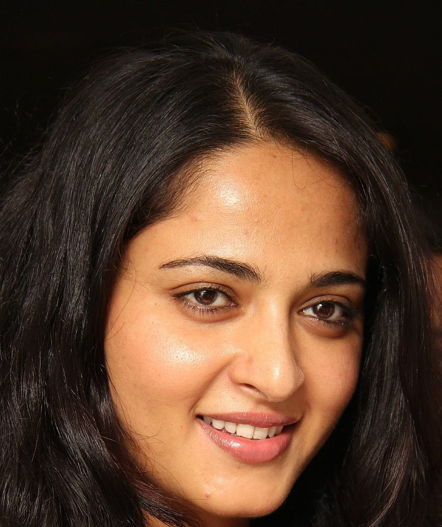 Anushka Shetty Portrait With Dark Hair And Warm Smile Against Black Background HD phone wallpaper