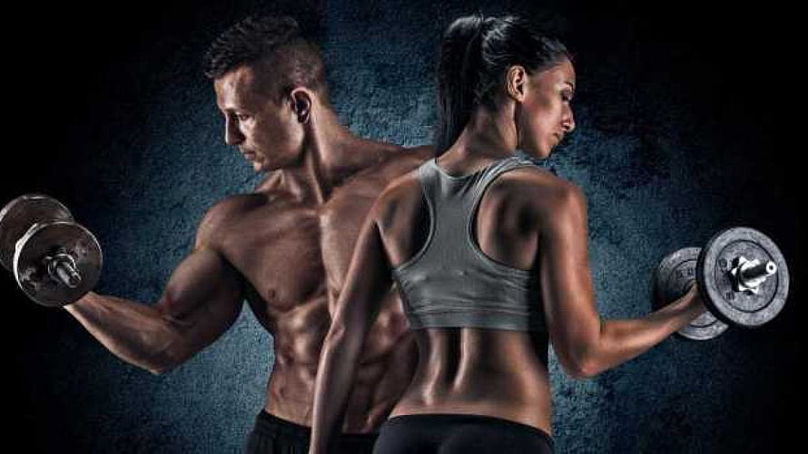 Muscular Man And Woman Lifting Dumbbells In Dark Gym Setting HD wallpaper