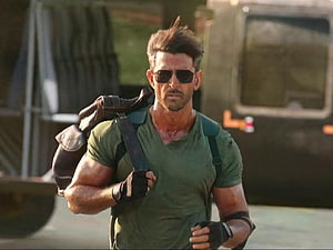 Hrithik Roshan in military action scene wearing sunglasses and tactical gear HD wallpaper