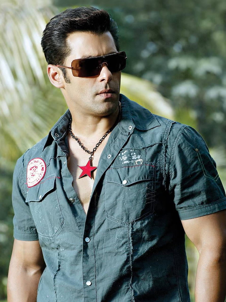 Salman Khan in a rugged military-style shirt with aviator sunglasses and a red star pendant necklace HD phone wallpaper