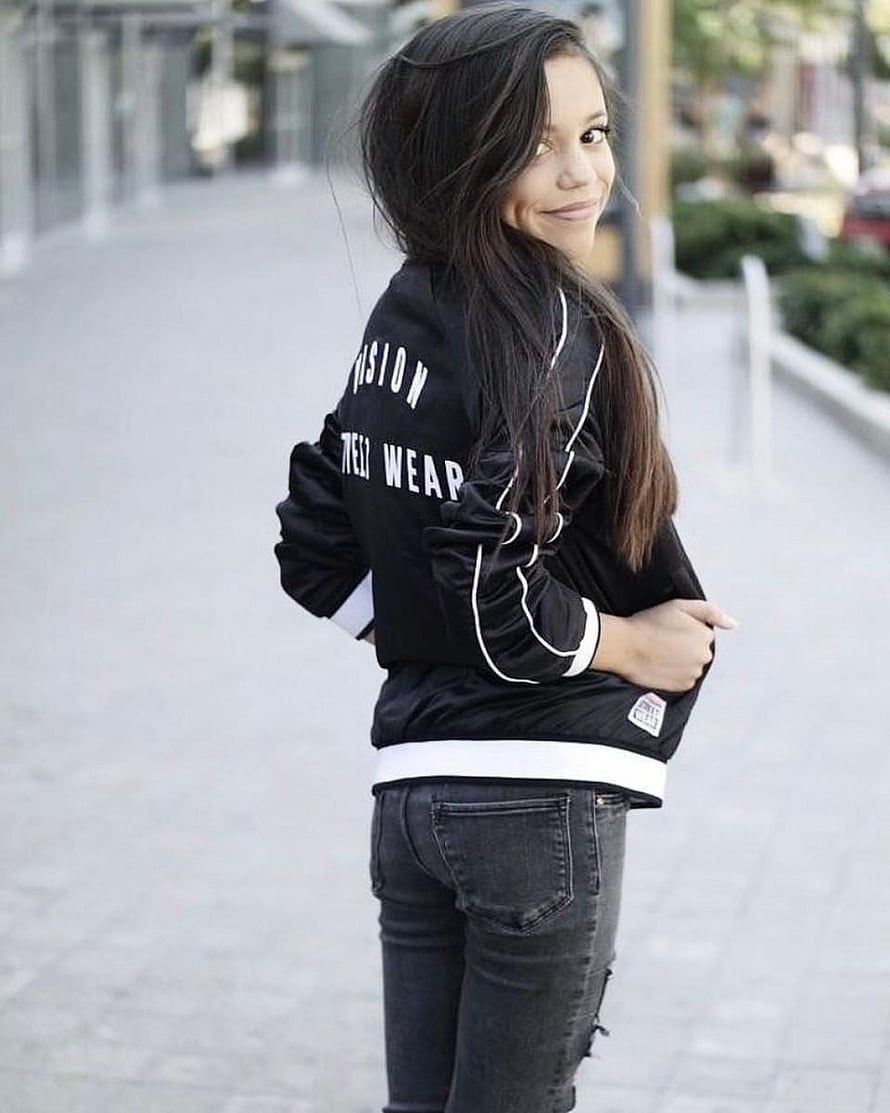 Jenna Ortega in Black Bomber Jacket and Dark Jeans on Urban Street HD phone wallpaper