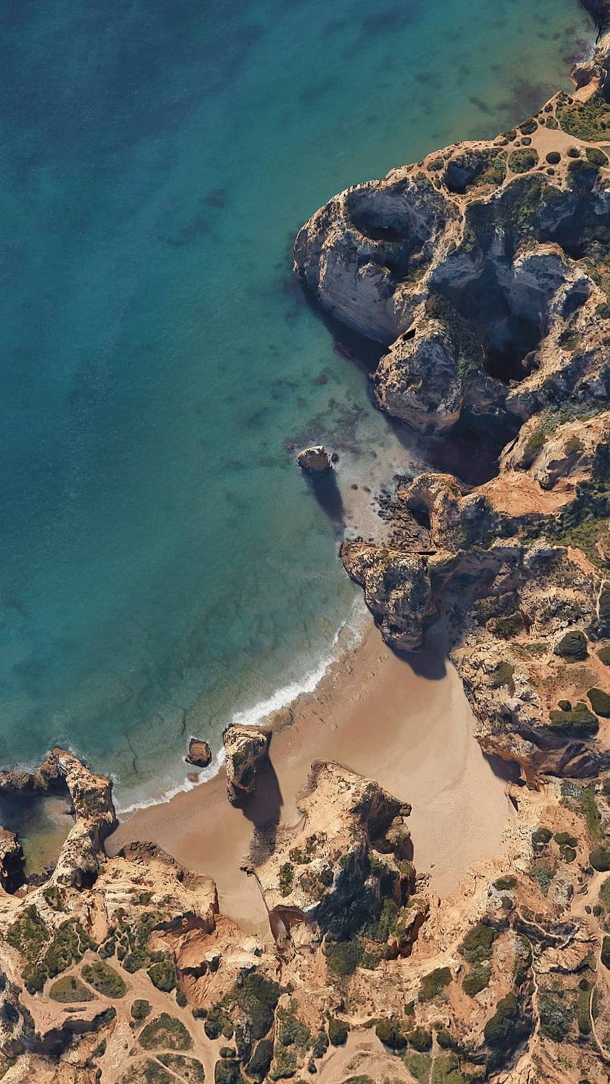 Aerial View of Turquoise Coastal Coves and Rugged Rocky Cliffs HD phone wallpaper