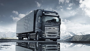 Volvo FH16 750 Heavy Duty Semi Truck with Snowy Mountain Backdrop and Water Reflection HD wallpaper