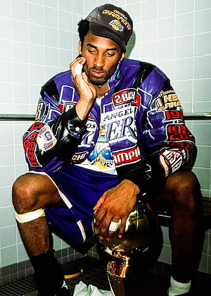 Kobe Bryant in Lakers Championship Jacket Holding Trophy in Locker Room HD phone wallpaper