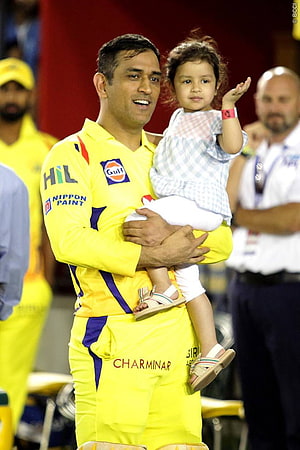 MS Dhoni holds his daughter in a yellow Chennai Super Kings cricket uniform HD phone wallpaper