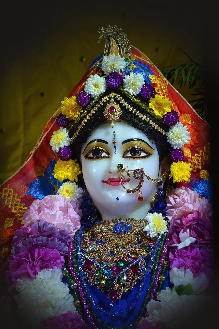 Srimati Radharani Deity Adorned in Vibrant Flowers and Ornate Jewelry HD phone wallpaper