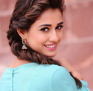 Disha Patani smiling portrait with braided hair and turquoise top HD wallpaper