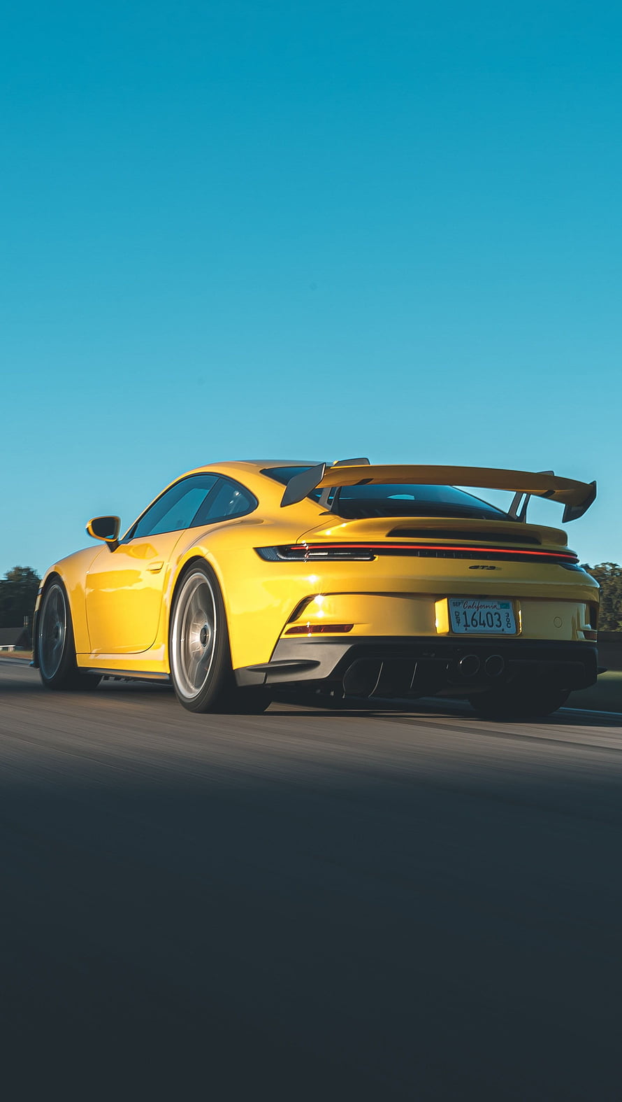 Yellow Porsche 911 GT3 2022 Rear View on Open Road Under Clear Blue Sky HD phone wallpaper