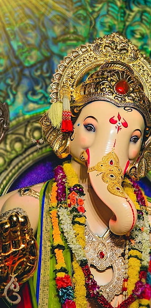 Ornate Chintamani Ganpati Murti Adorned With Gold Crown And Vibrant Flower Garlands HD phone wallpaper