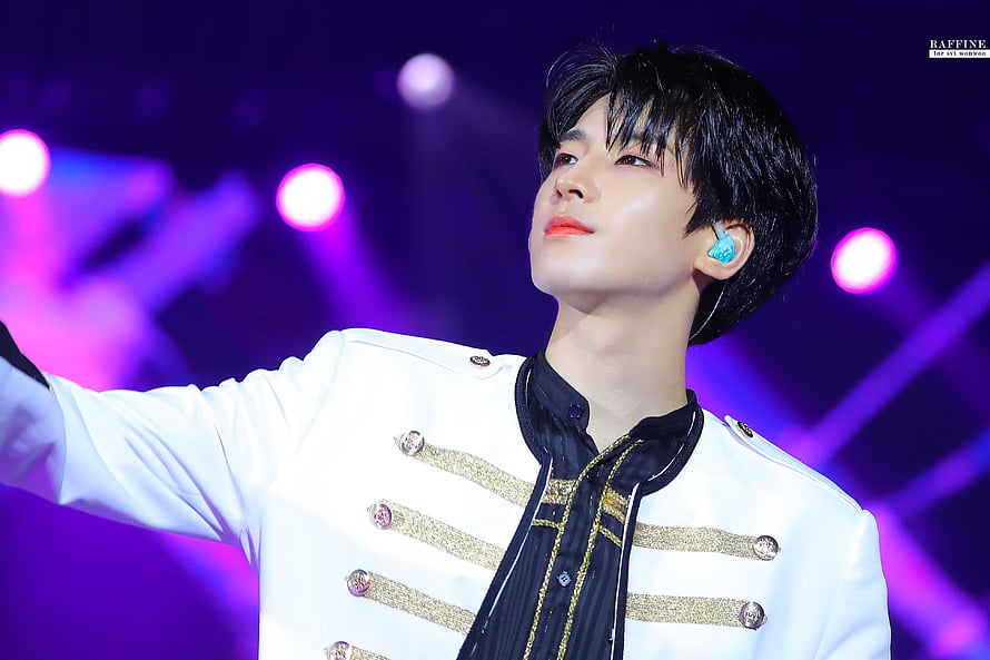 Wonwoo from ATEEZ performing on stage in a white military-style jacket with gold accents HD wallpaper