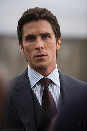 Christian Bale as Bruce Wayne in a formal pinstripe suit and dark tie HD phone wallpaper