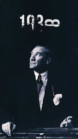 Mustafa Kemal Ataturk in a formal suit with a pocket watch chain, looking upward in a dramatic black and white portrait HD phone wallpaper