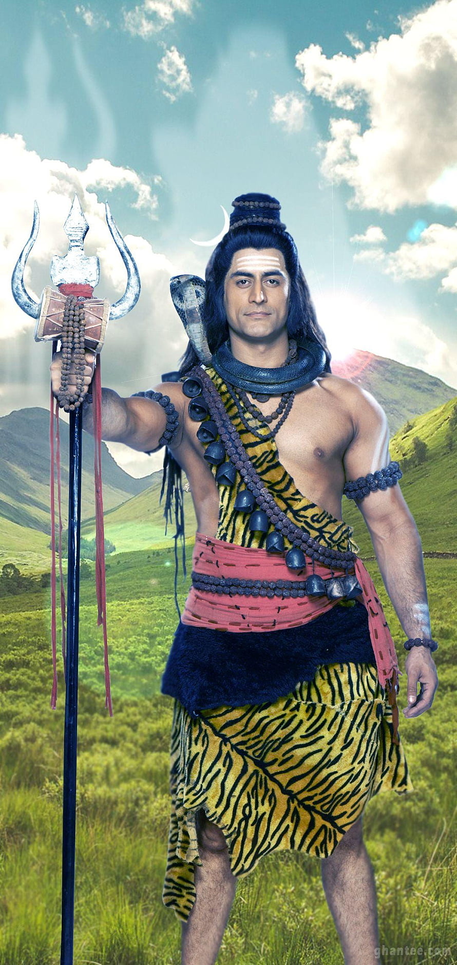 Lord Shiva in tiger skin with trident and cobra in a green mountain landscape HD phone wallpaper