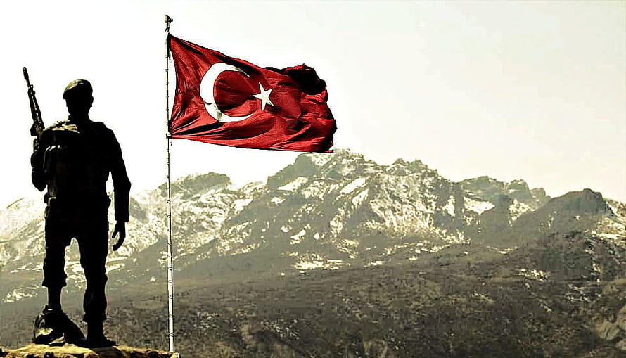 Silhouetted Soldier Standing Guard with Turkish Flag Against Snowy Mountain Range HD wallpaper