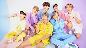 BTS Members in Pastel Colorful Outfits on Vibrant Background HD wallpaper
