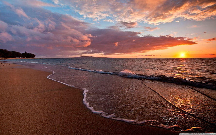 Golden Sunset Over a Serene Tropical Beach with Gentle Waves and Dramatic Clouds HD wallpaper