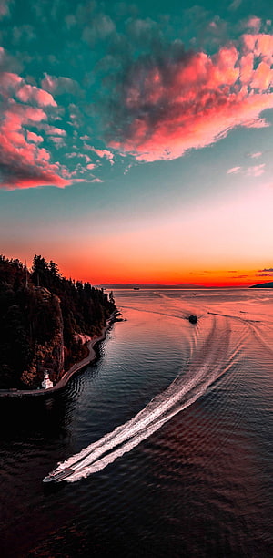 Aerial View of a Ferry Crossing a Fjord at Sunset with Dramatic Pink Clouds HD phone wallpaper