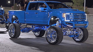 Blue Lifted Ford F-150 with Chrome Wheels at SEMA Show Night Cruise HD wallpaper